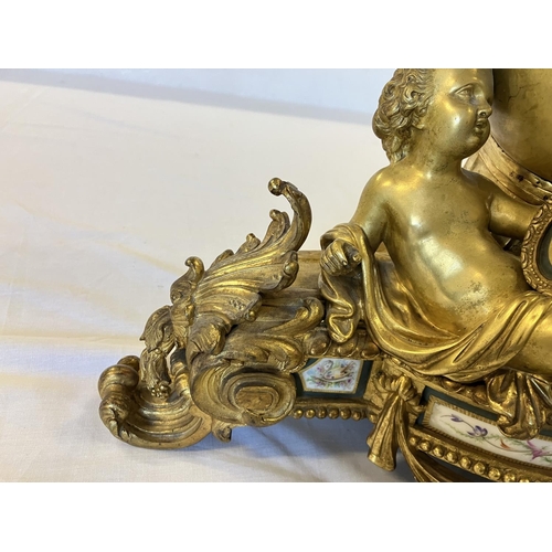 307 - A fine 19th century gilded brass mantle clock, the clock decorated with cherub figures and porcelain... 