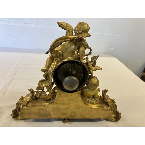 307 - A fine 19th century gilded brass mantle clock, the clock decorated with cherub figures and porcelain... 