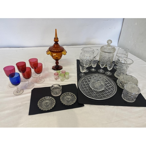 314 - Mixed lot of glass ware to include colour glass urn and lid, red glass goblets, jugs, vases, etc.