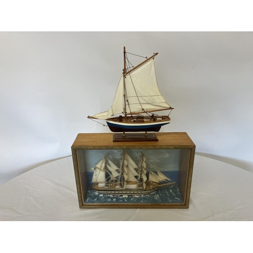 38 - Cased model of a ship and a model of a yacht. Case size - W. 47cm, H. 30cm, D. 14cm approx. (2)