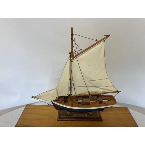 38 - Cased model of a ship and a model of a yacht. Case size - W. 47cm, H. 30cm, D. 14cm approx. (2)