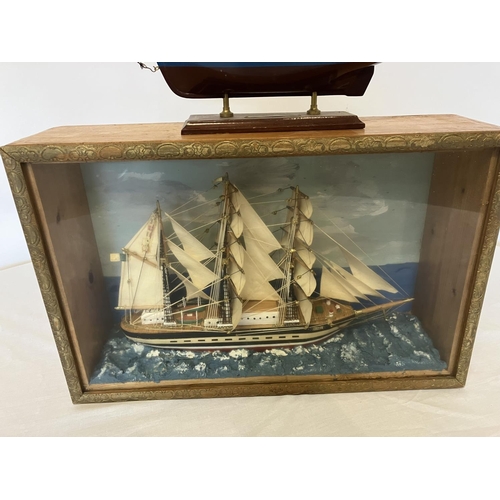 38 - Cased model of a ship and a model of a yacht. Case size - W. 47cm, H. 30cm, D. 14cm approx. (2)