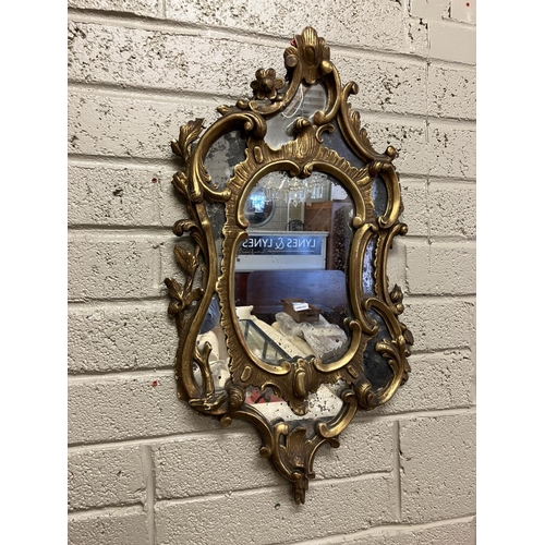 64 - Antique decorative gilt framed wall mirror. L. 80cm, W. 45cm approx.