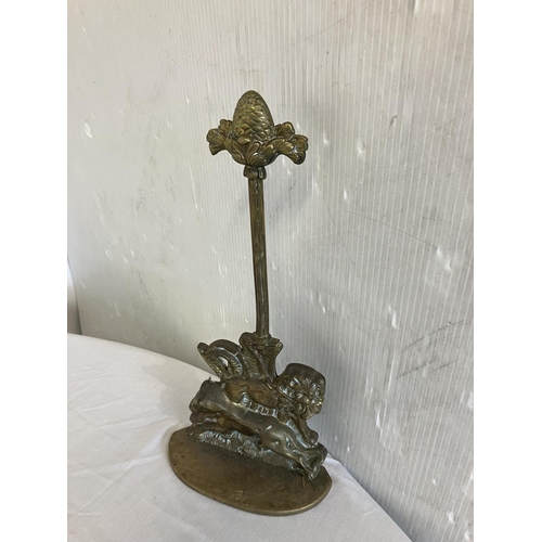 76 - Good old brass door stop. H. 38cm.
