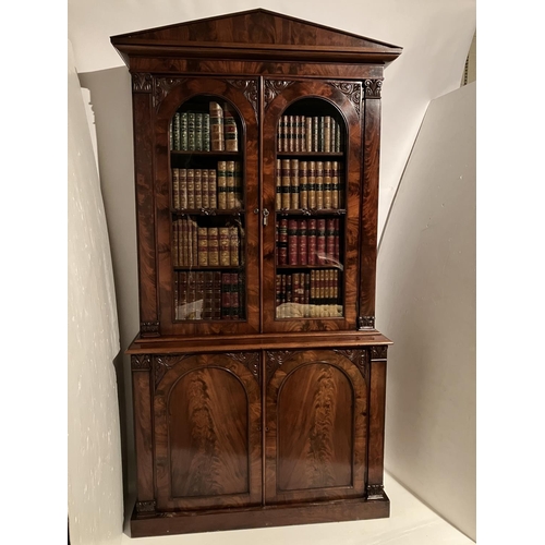 100 - A fine Victorian figured mahogany bookcase, the upper section having shaped cornice over mahogany an... 