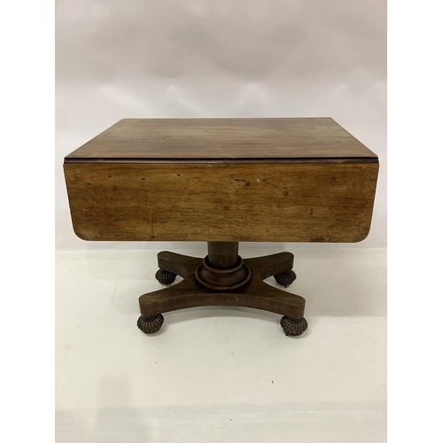 105 - A 19th century rosewood drop leaf table fitted with real & dummy drawers and raised on centre column... 