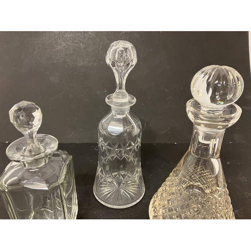 112 - Three cut glass decanters and stoppers.