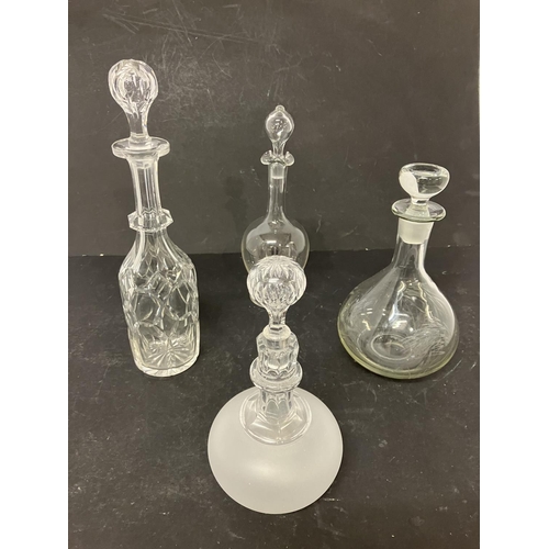 121 - Four glass decanters and stoppers.