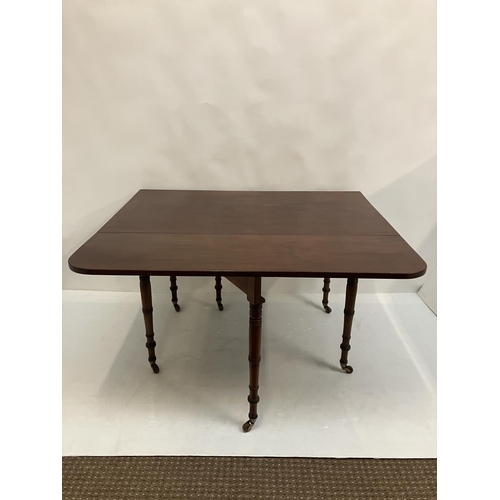 122 - A good Georgian mahogany drop leaf dining table raised on ring turned legs. W. 125cm. L. 140cm appro... 