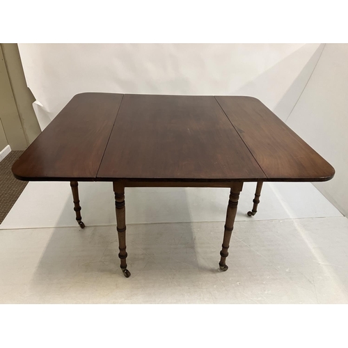 122 - A good Georgian mahogany drop leaf dining table raised on ring turned legs. W. 125cm. L. 140cm appro... 