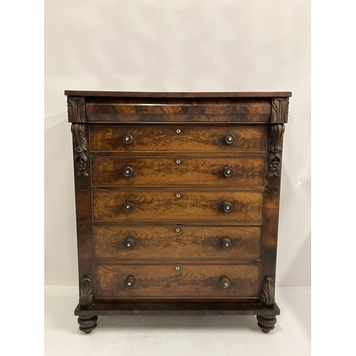 130 - A large Victorian feathered mahogany chest of 6 graduated drawers with carved decoration and raised ... 