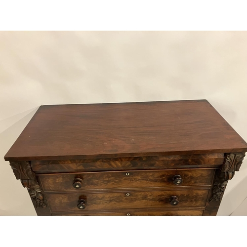 130 - A large Victorian feathered mahogany chest of 6 graduated drawers with carved decoration and raised ... 