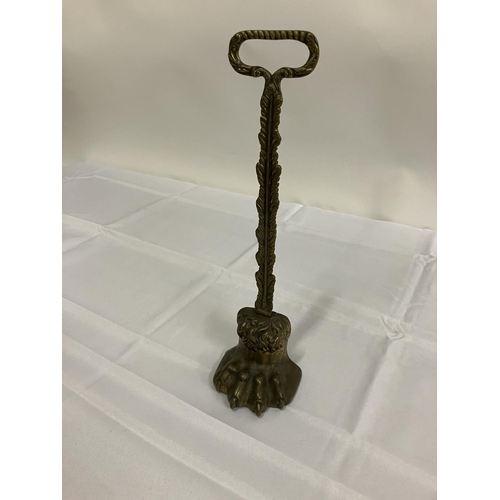 134 - Antique brass lions claw door stop.