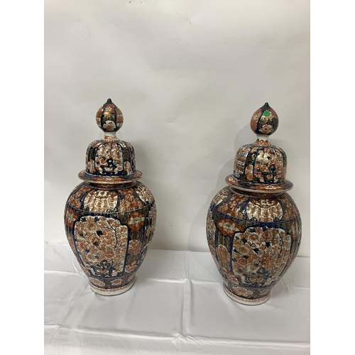 135 - A good pair of early 19th century Imari china jars and lids. H. 67cm.