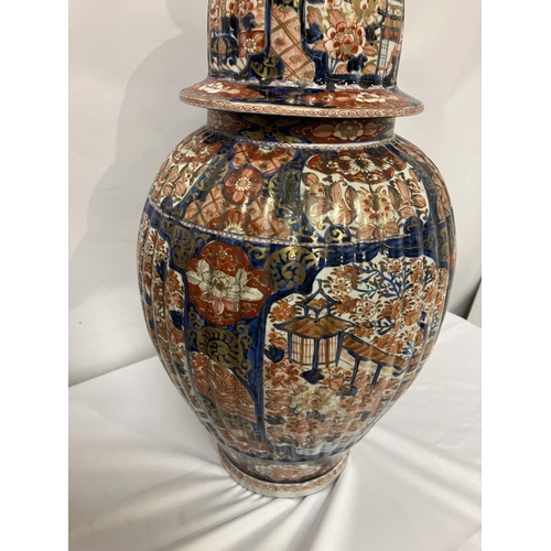 135 - A good pair of early 19th century Imari china jars and lids. H. 67cm.