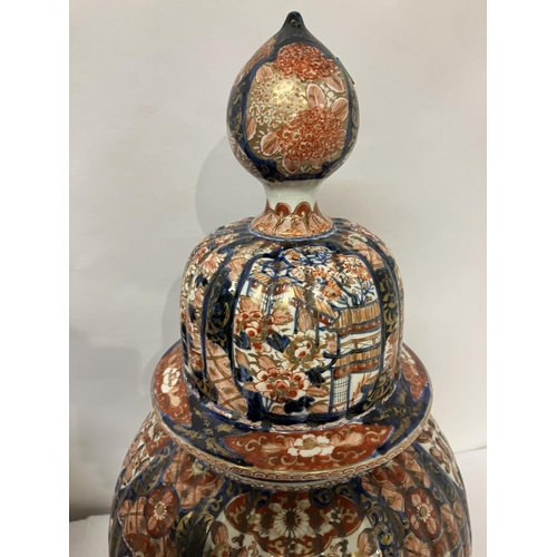 135 - A good pair of early 19th century Imari china jars and lids. H. 67cm.