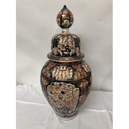 135 - A good pair of early 19th century Imari china jars and lids. H. 67cm.