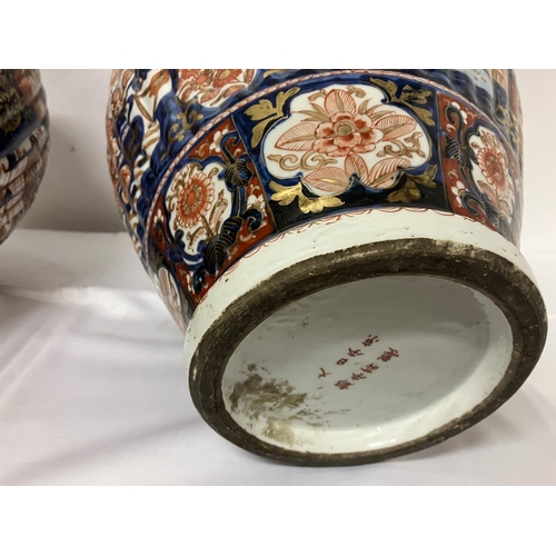 135 - A good pair of early 19th century Imari china jars and lids. H. 67cm.