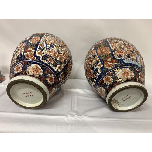 135 - A good pair of early 19th century Imari china jars and lids. H. 67cm.