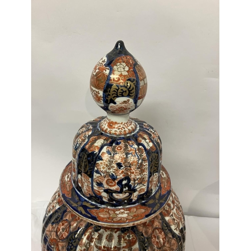 135 - A good pair of early 19th century Imari china jars and lids. H. 67cm.