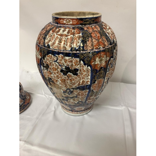 135 - A good pair of early 19th century Imari china jars and lids. H. 67cm.