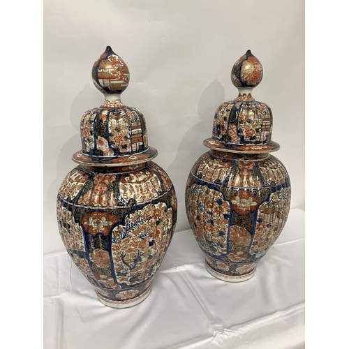 135 - A good pair of early 19th century Imari china jars and lids. H. 67cm.