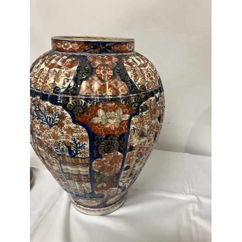 135 - A good pair of early 19th century Imari china jars and lids. H. 67cm.