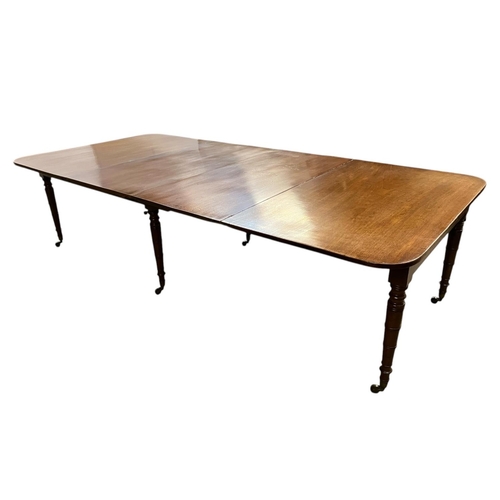 146 - A fine Irish Georgian mahogany dining table having 2 extra leaves and raised on ring turned legs. Le... 