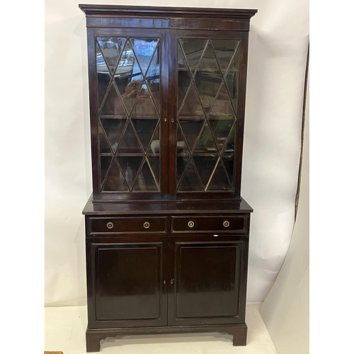 147 - A 19th century mahogany bookcase, the upper section having two glazed diamond doors, the base fitted... 