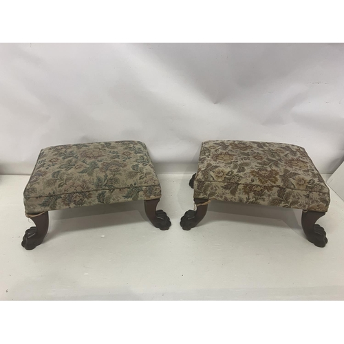 149 - A pair of rectangular shaped stools raised on mahogany legs with lion claw feet. 57cm x 53cm.