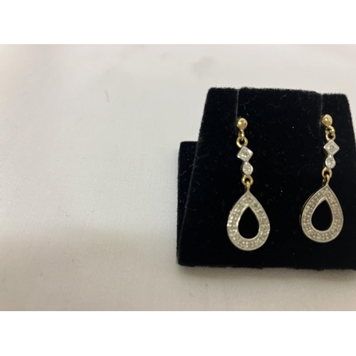 199 - A pair of 9ct diamond drop earrings.