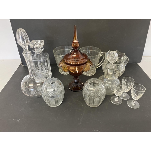 22 - Lot of glassware to include jugs, decanters and amber glass urn and lid.