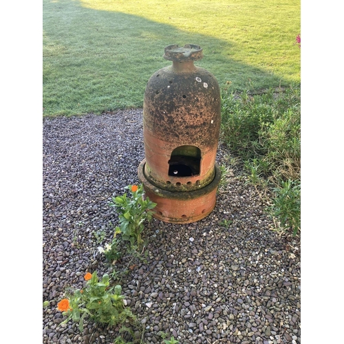 220 - An interesting old terracotta garden or conservatory heater. ( in 2 parts) H. 94cm.