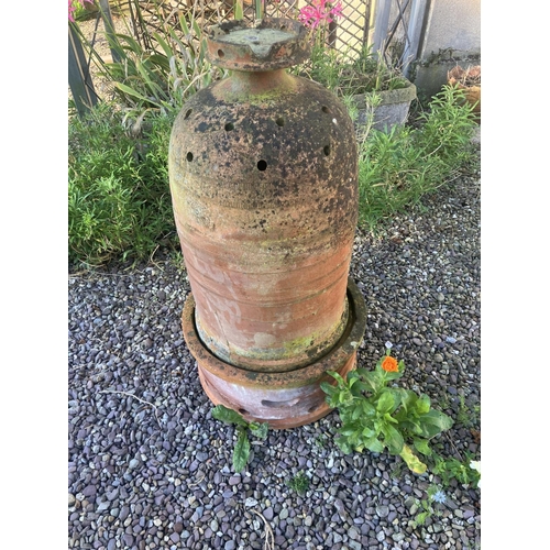 220 - An interesting old terracotta garden or conservatory heater. ( in 2 parts) H. 94cm.