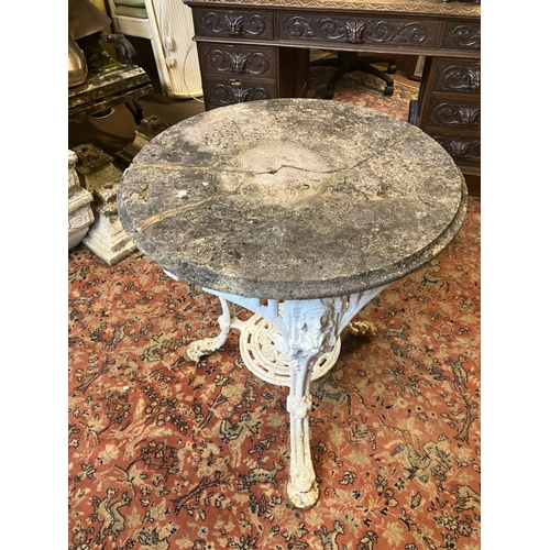 225 - Antique cast iron garden table with stone top, the table has a few old repairs and the stone top is ... 