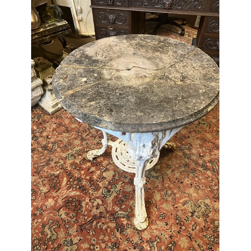 225 - Antique cast iron garden table with stone top, the table has a few old repairs and the stone top is ... 