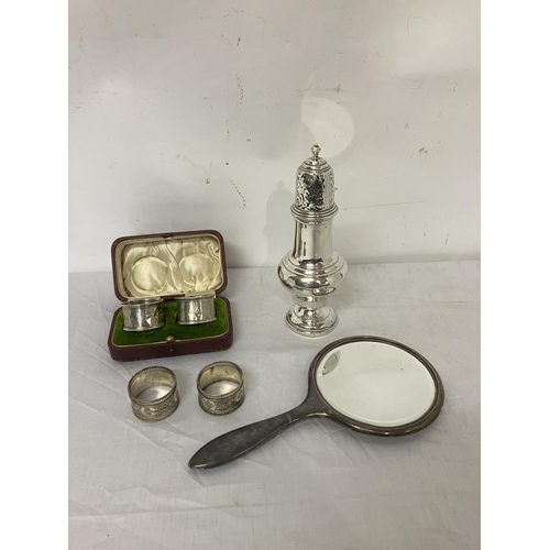 243 - Silver sugar castor, Birmingham 1917 (few dents); a pair of cased silver napkin rings, Birmingham 19... 