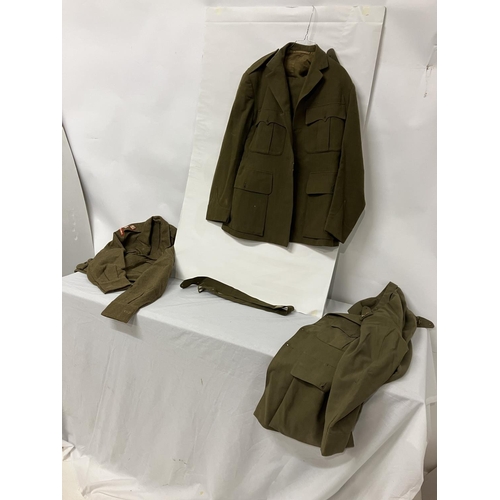 266 - A World War II Military Uniform - jacket, trousers, belt (insignia removed) and two other jackets.