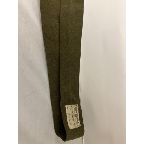 266 - A World War II Military Uniform - jacket, trousers, belt (insignia removed) and two other jackets.