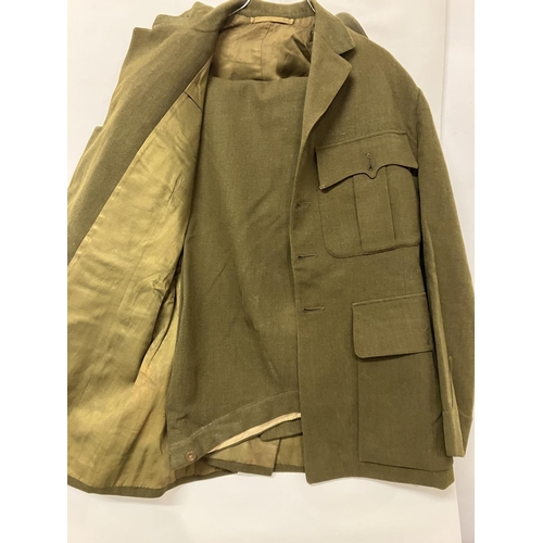 266 - A World War II Military Uniform - jacket, trousers, belt (insignia removed) and two other jackets.