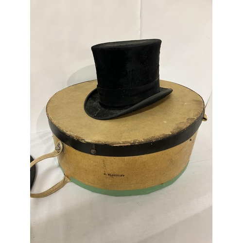 276 - Hat box containing hard top hat from the Munster Arcade Cork together with a folding top hat from Th... 