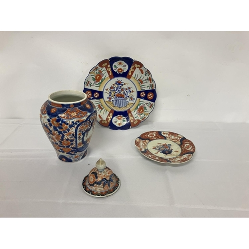 278 - Large and small Imari wall plates and an Imari urn and lid. (2 chips on rim of lid)