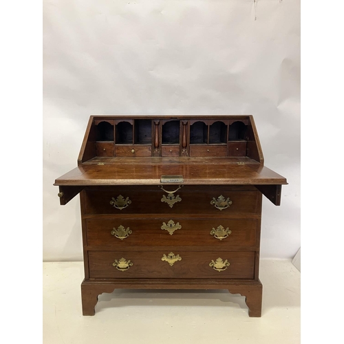 297 - Georgian mahogany slope front bureau having fitted interior, four graduated drawers with brass handl... 