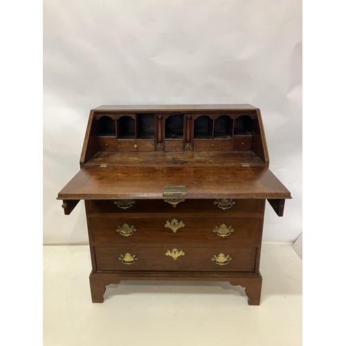 297 - Georgian mahogany slope front bureau having fitted interior, four graduated drawers with brass handl... 