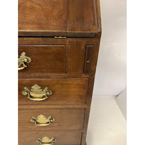 297 - Georgian mahogany slope front bureau having fitted interior, four graduated drawers with brass handl... 