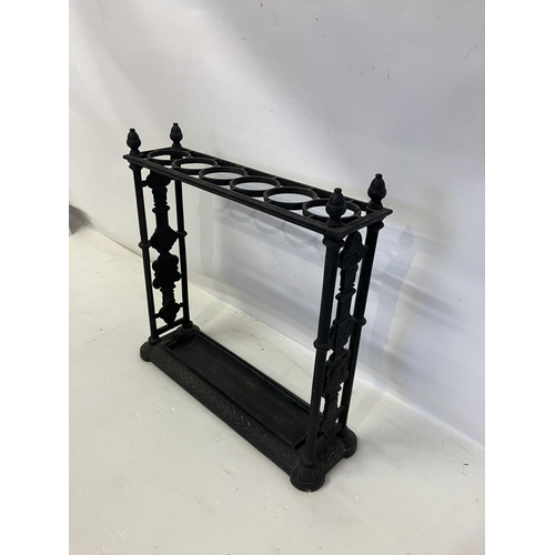 299 - Antique cast iron umbrella stand complete with drip tray.