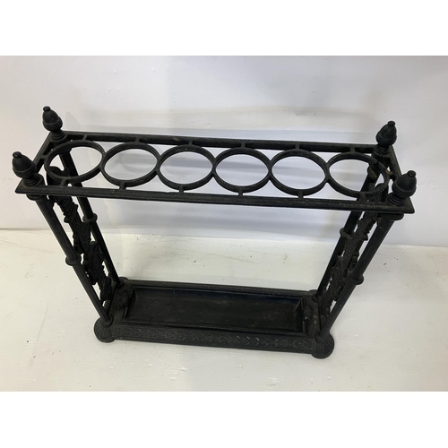 299 - Antique cast iron umbrella stand complete with drip tray.