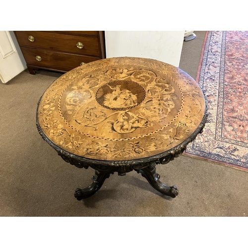 300 - A good 19th century circular table, the extensive inlaid top having carved border and raised on simi... 