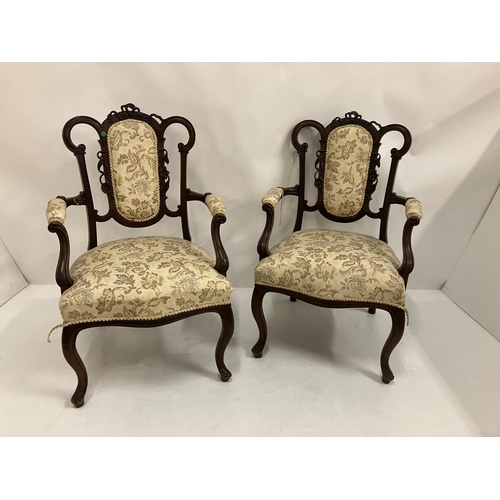 327 - A pair of attractive Edwardian open arm chairs. (repair on arm)