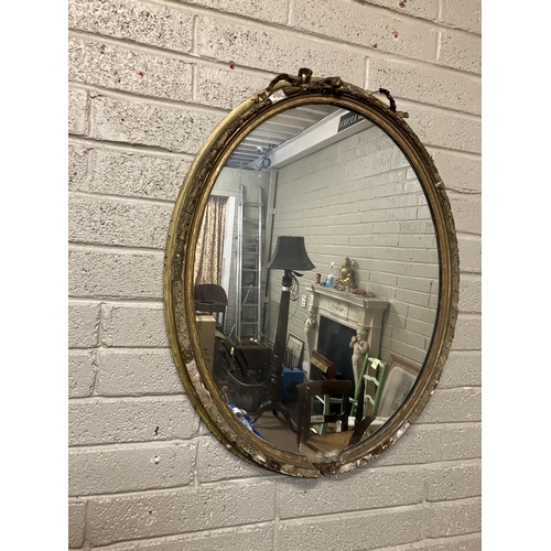 39 - Large antique oval shaped gilt framed mirror with original glass, framed needing restoration. H. 110... 